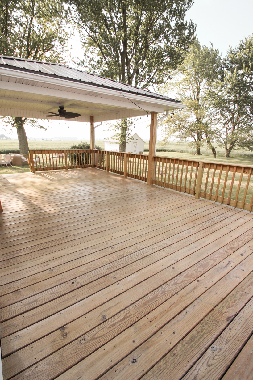 Interior decorator and home blogger Liz Fourez shares everything you need to know about staining a deck from prep to finish!