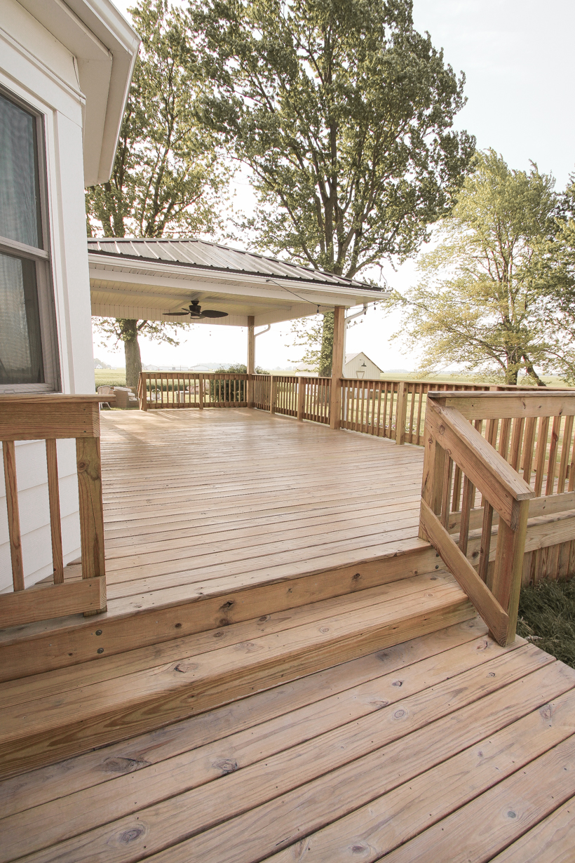 Interior decorator and home blogger Liz Fourez shares everything you need to know about staining a deck from prep to finish!