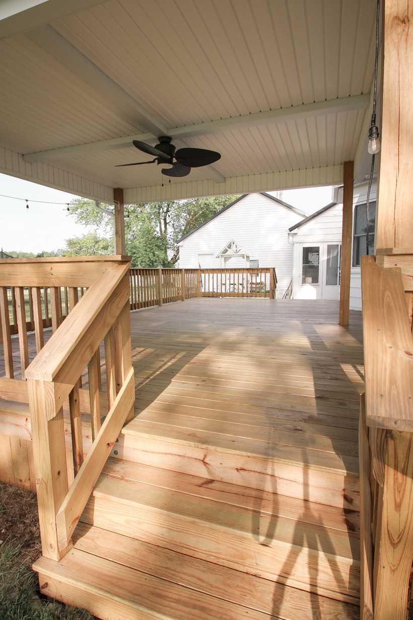 Interior decorator and home blogger Liz Fourez shares everything you need to know about staining a deck from prep to finish!