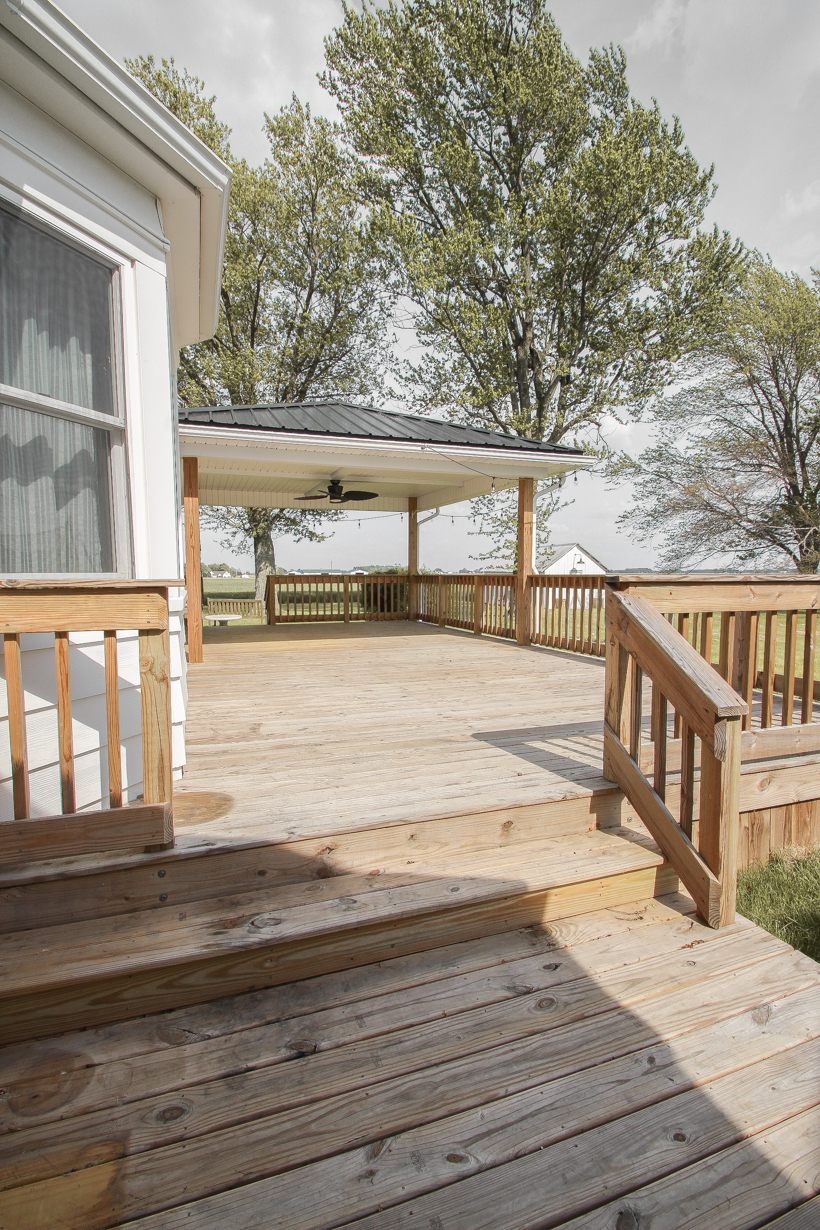 Interior decorator and home blogger Liz Fourez shares everything you need to know about staining a deck from prep to finish!