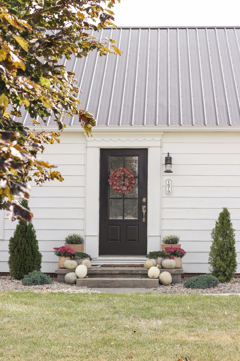 Home blogger and interior decorator Liz Fourez shares her small front porch decorated for fall with the perfect mix of soft neutrals and subtle color.