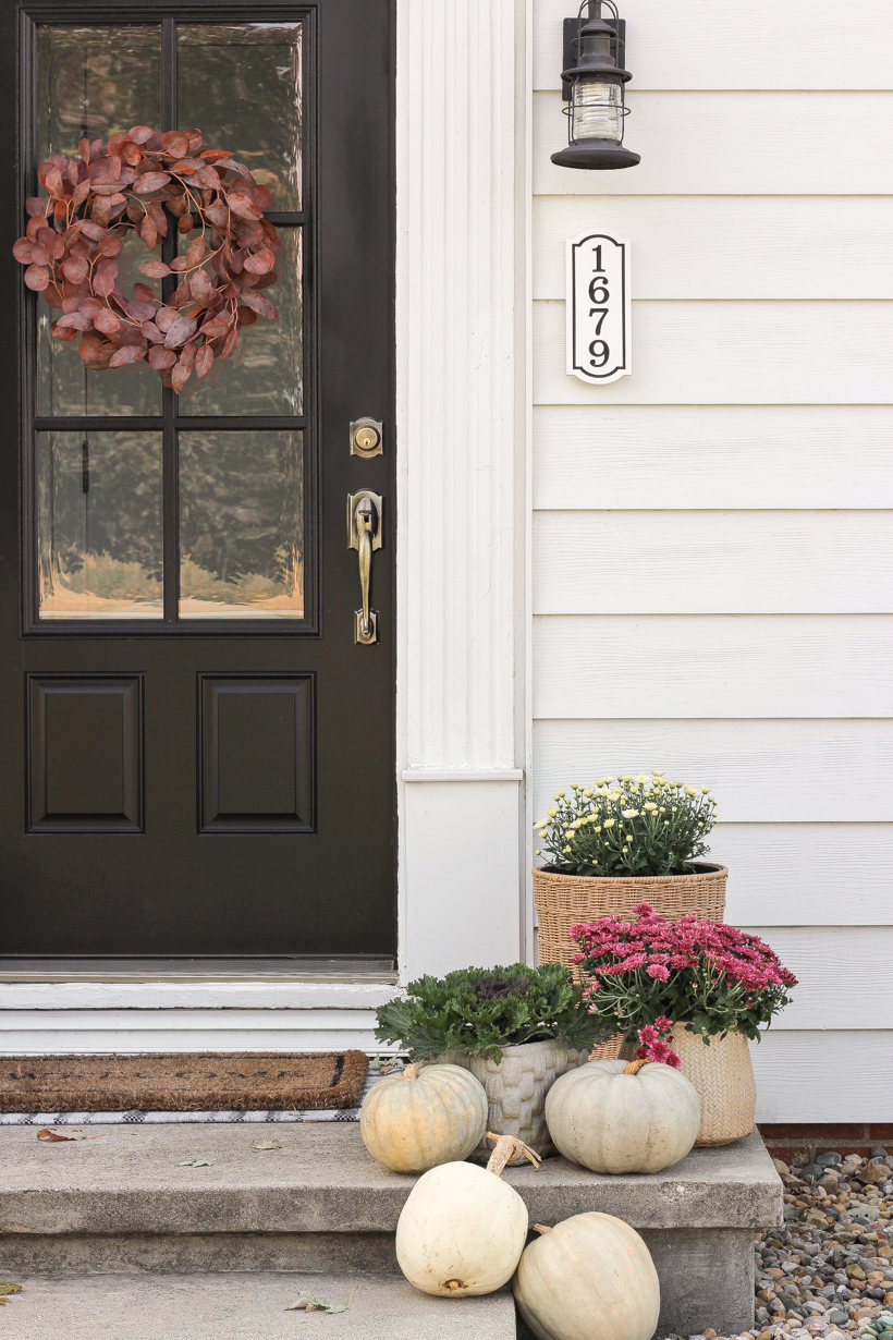 Home blogger and interior decorator Liz Fourez shares her small front porch decorated for fall with the perfect mix of soft neutrals and subtle color.