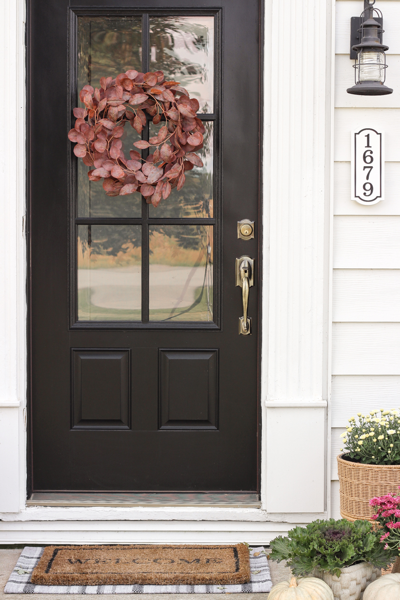 Home blogger and interior decorator Liz Fourez shares her small front porch decorated for fall with the perfect mix of soft neutrals and subtle color.