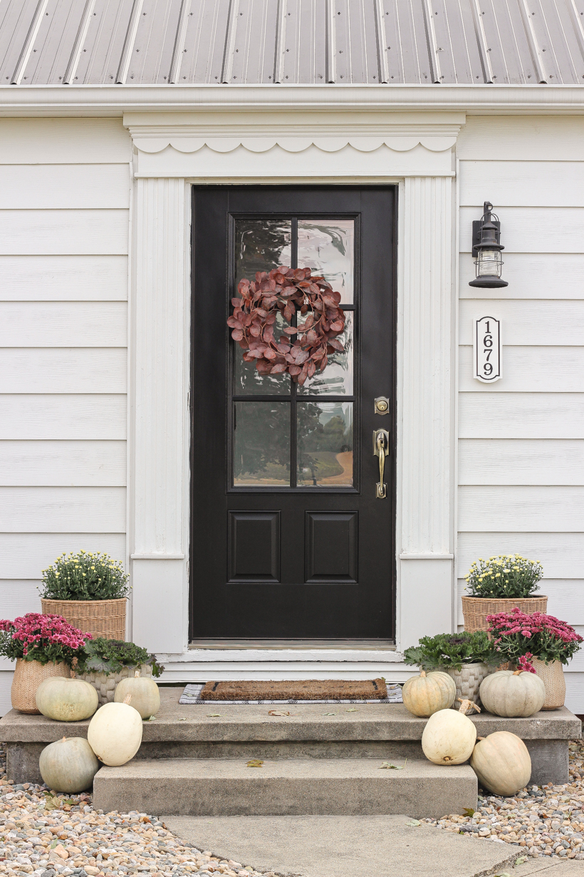 Home blogger and interior decorator Liz Fourez shares her small front porch decorated for fall with the perfect mix of soft neutrals and subtle color.