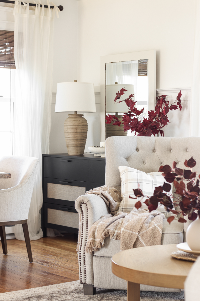 Home blogger and interior decorator Liz Fourez shares a beautiful fall vignette in her dining room featuring deep red fall branches and a new furniture find that has a high-end look without the high-end price