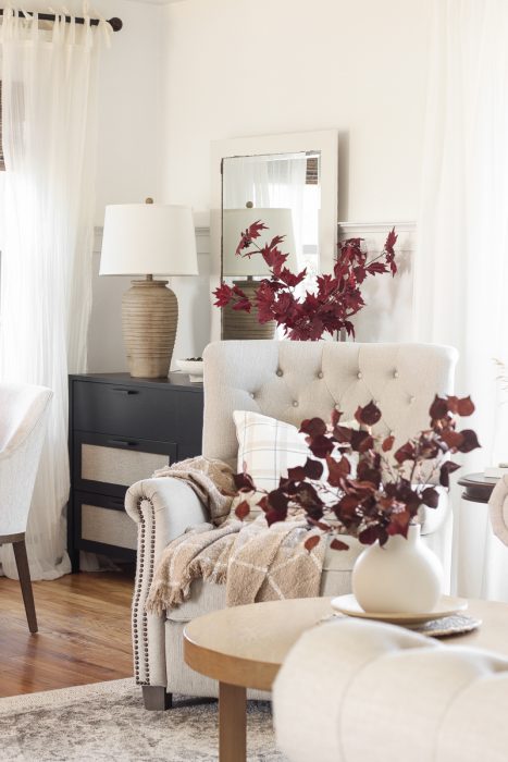 Home blogger and interior decorator Liz Fourez shares a beautiful fall vignette in her dining room featuring deep red fall branches and a new furniture find that has a high-end look without the high-end price