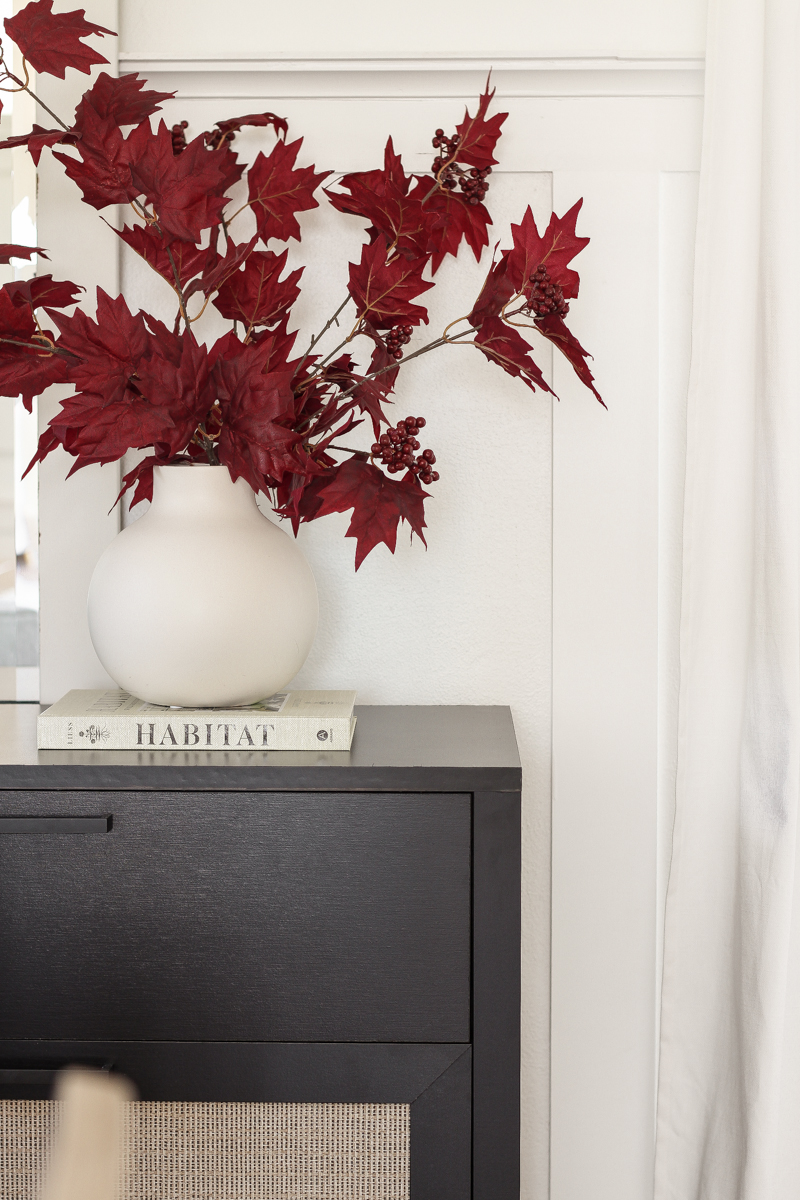 Home blogger and interior decorator Liz Fourez shares a beautiful fall vignette in her dining room featuring deep red fall branches and a new furniture find that has a high-end look without the high-end price