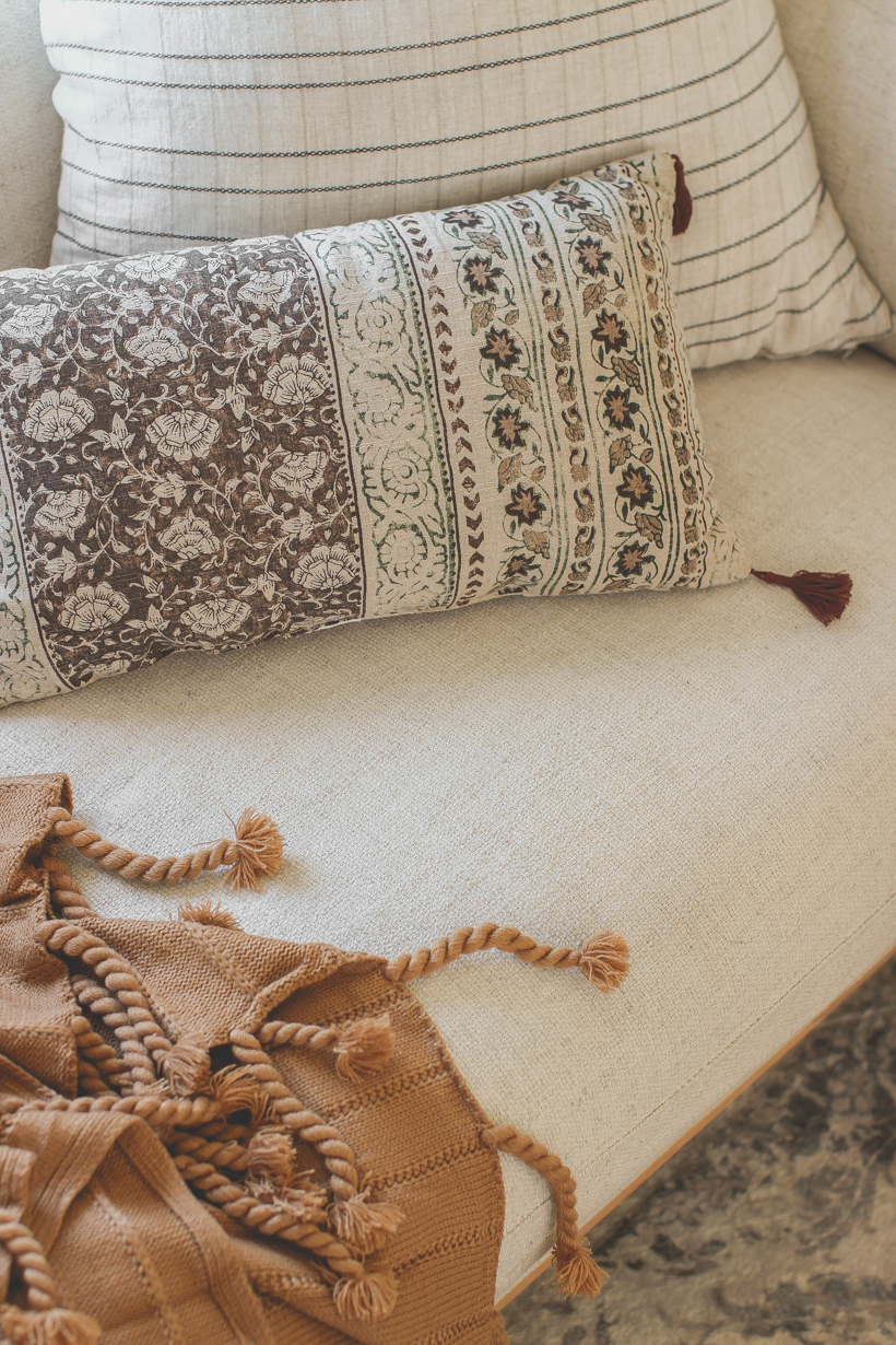 The prettiest throw pillows and blankets for fall that will instantly cozy up your home - curated by home blogger and interior decorator Liz Fourez