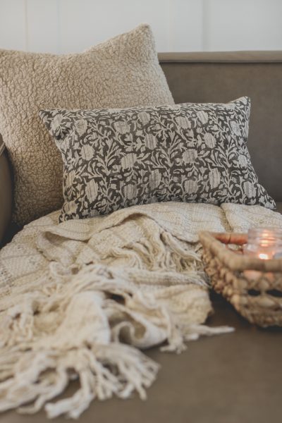 The prettiest throw pillows and blankets for fall that will instantly cozy up your home - curated by home blogger and interior decorator Liz Fourez
