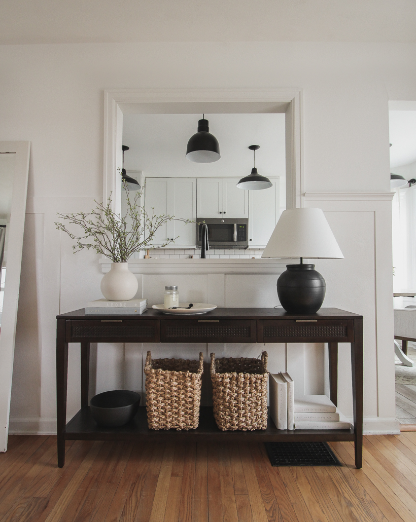 A beautiful dark wood console table styled in the home of blogger and interior decorator Liz Fourez