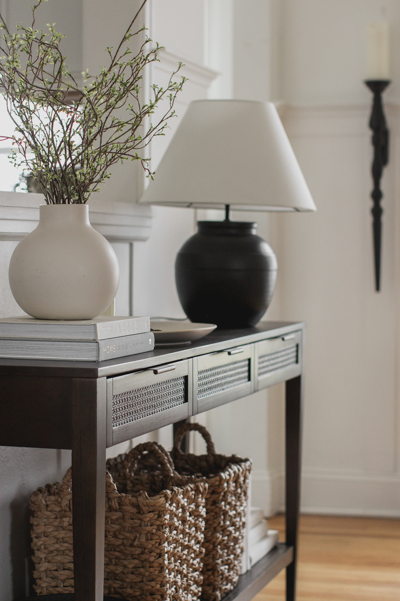 A beautiful dark wood console table styled in the home of blogger and interior decorator Liz Fourez