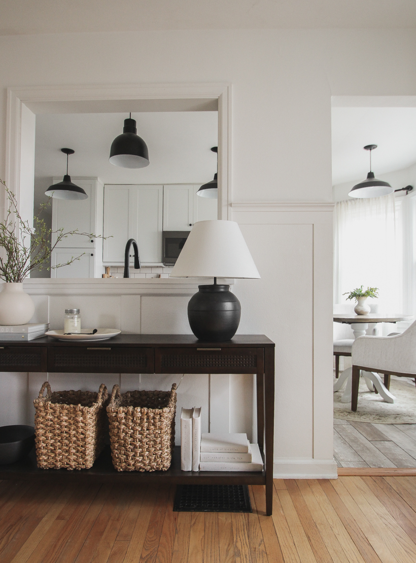 A beautiful dark wood console table styled in the home of blogger and interior decorator Liz Fourez